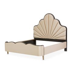 an upholstered bed with a shell shaped headboard and foot board in beige leather
