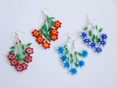 three pairs of beaded earrings with flowers on them