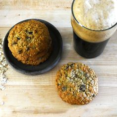 two cookies and a glass of beer on a table