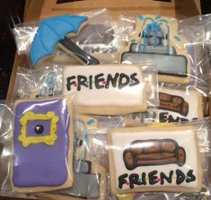 decorated cookies in plastic wrappers with the words friends and umbrellas written on them