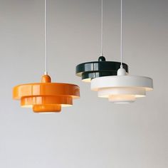 three different colored lights hanging from the ceiling