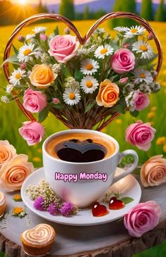 a cup of coffee and some flowers on a table with the words happy monday written in it