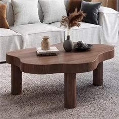 a living room with white couches and a coffee table in front of the couch