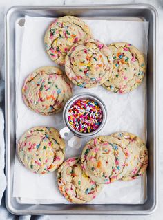 cookies with sprinkles and confetti in a cookie tin