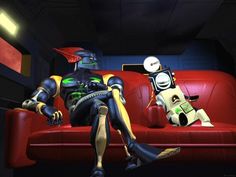 two animated characters sitting on a red couch in a dark room, one is talking to the other