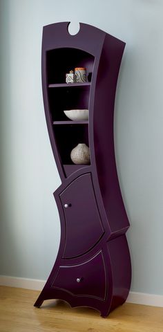 a purple curved shelf with some rocks in it
