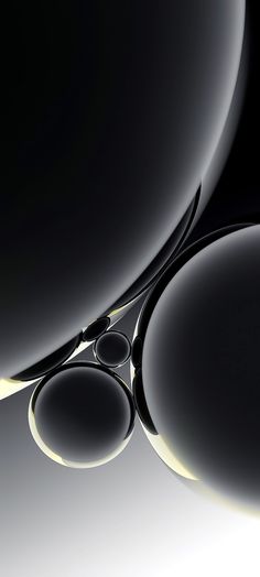 a pair of scissors sitting on top of a black object in the middle of an image