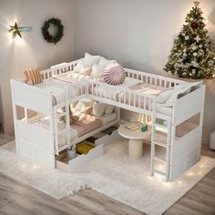 a white bunk bed sitting on top of a wooden floor next to a christmas tree