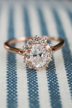 a close up of a diamond ring on a striped cloth