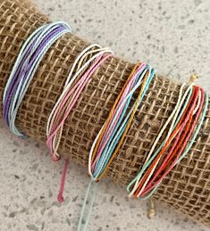 a roll of burlap with various colored thread on it