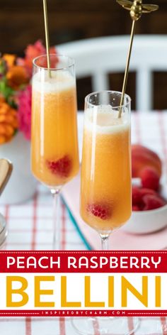 two glasses of peach raspberry bellini on a table