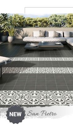 an outdoor living room with black and white tiles on the floor, couches and tables