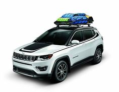 a white jeep with luggage strapped to it's roof is parked in front of a white background