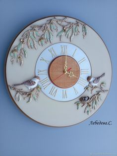 a clock that has birds on it