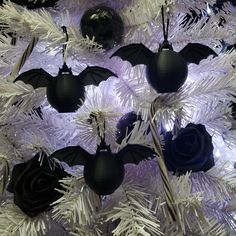 bats and roses are hanging on the christmas tree