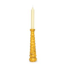 a yellow candle holder on a white background