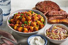 a table topped with bowls filled with food