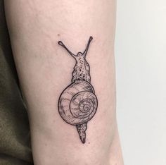 a small snail tattoo on the right thigh and lower leg, it is black and white