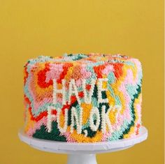 a colorful cake with the words happy new york on it's icing and frosting
