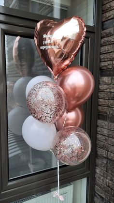 some balloons that are in front of a window