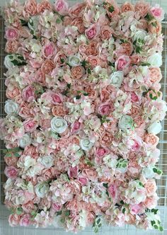 pink flowers are arranged in the shape of a wall