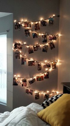 a bedroom decorated with lights and pictures on the wall