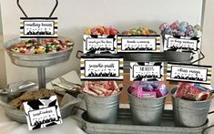 an assortment of desserts and candies displayed in buckets