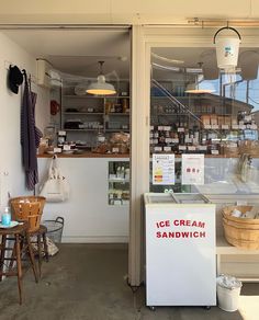 an ice cream sandwich shop with lots of items behind the glass door and on the outside