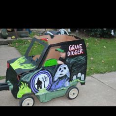 a child's ride - on toy car decorated to look like a grave digger