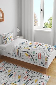 a child's bedroom with a toy train bed and rugs on the floor