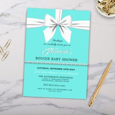 a blue and white baby shower with a bow on it