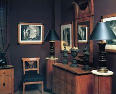 a living room with two lamps and pictures on the wall