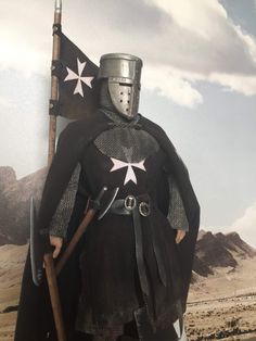 a man dressed in armor and holding a flag