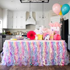 a table covered with colorful streamers and balloons