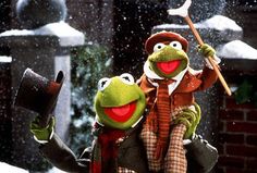 the muppets are holding an umbrella in the snow