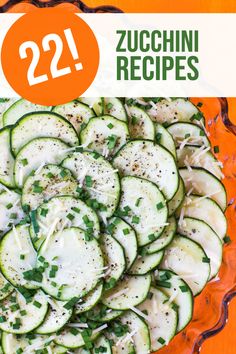 zucchini with parmesan cheese and herbs in a glass dish on an orange table