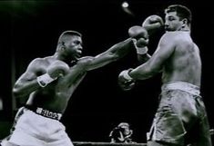 two men boxing in an old black and white photo