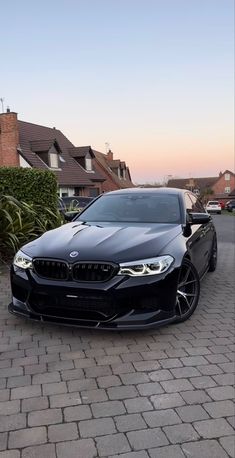 a black car parked in front of some houses