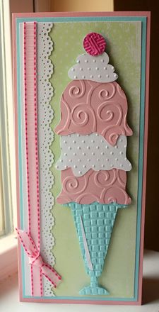 a handmade card with an ice cream cone on the front, and pink ribbon around the edge