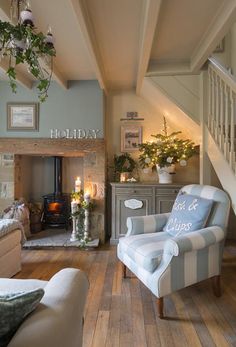 a living room filled with furniture and a fire place next to a stair case in front of a fireplace