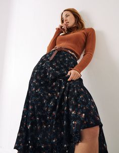 Spring into winter in this super versatile ditsy print skirt. It comes in a flattering fit, with a ruffled design and floral graphics. Style it with a snug sweater and boots, or layer it with tights and a cardi for the colder days. Dark Floral Maxi Skirt, Midi Skirts Winter, Midsize Skirt Outfit Winter, Late 90s Fall Fashion, Long Polka Dot Skirt Outfit, Navy Floral Skirt, Dark Eclectic Outfit, Older Goth Fashion, Layer Over Dress