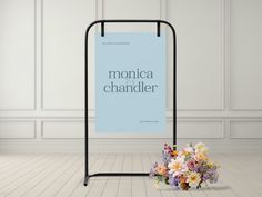 there is a blue sign with the words monica chandler on it next to a bouquet of flowers