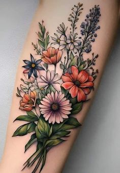 a tattoo with flowers and leaves on the arm, it is very nice to see