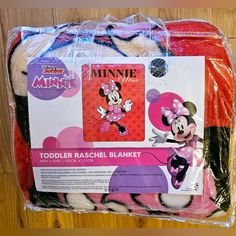 the package is wrapped in plastic and has minnie mouse on it