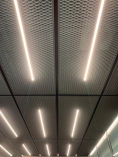 the interior of an office building with lights on and ceiling lighting in place to illuminate light