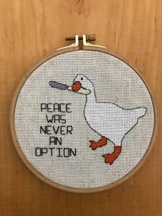 a white duck with a baseball bat in it's beak and the words peace was never an option