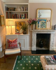 a living room filled with furniture and a fire place in front of a book shelf