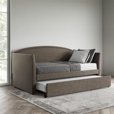 a day bed with pull out trundle and pillows on it in a room