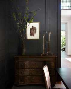 a table with a vase and some branches on it