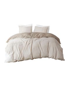 a white bed with two pillows on top of it